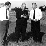 Six men standing in the field.