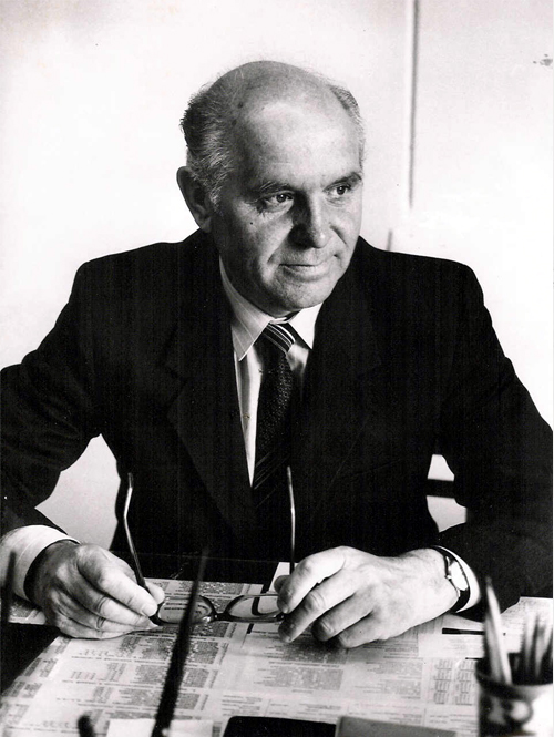 A portrait of Ivan Ovcharenko holding glasses.